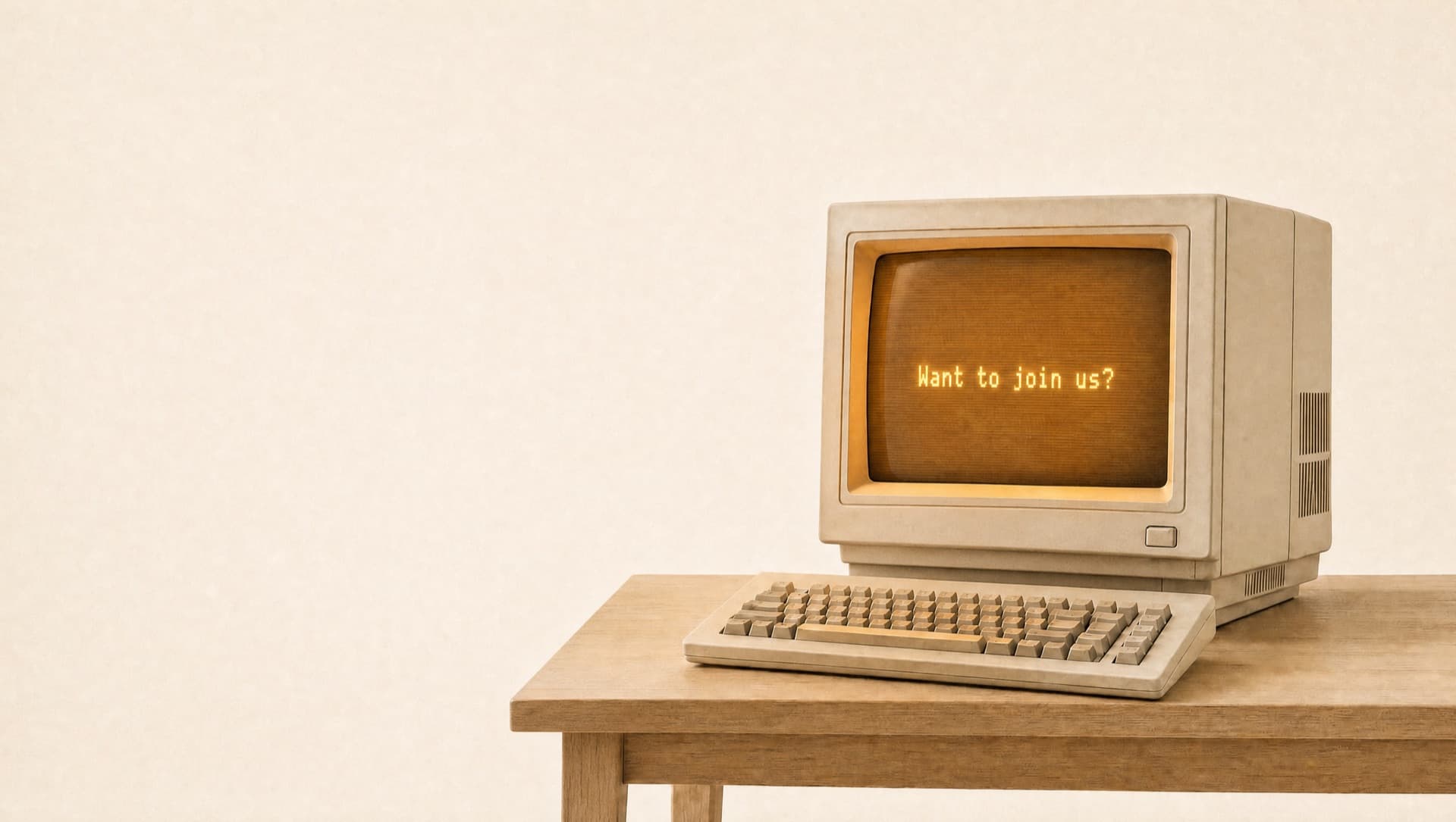 A vintage computer screen glowing with the words “Want to join us?”